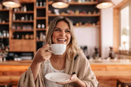 Woman having coffee and smiling